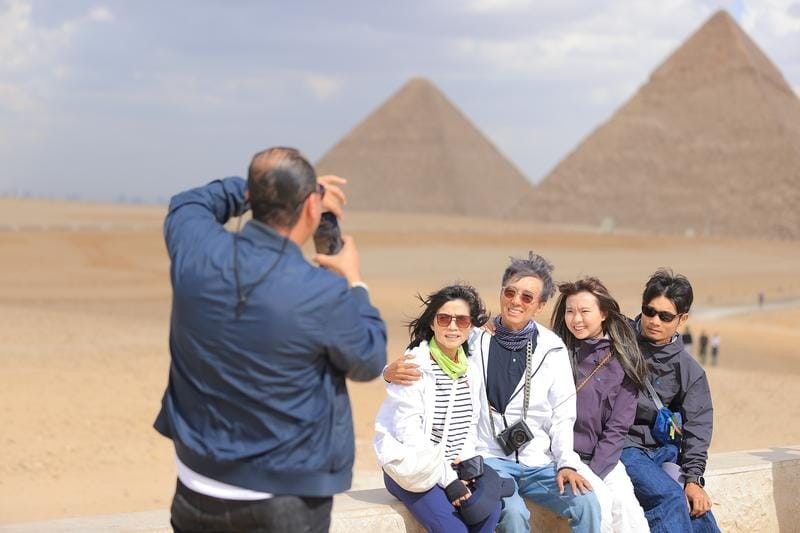 Chinese tourists visit the Pyramids of Giza